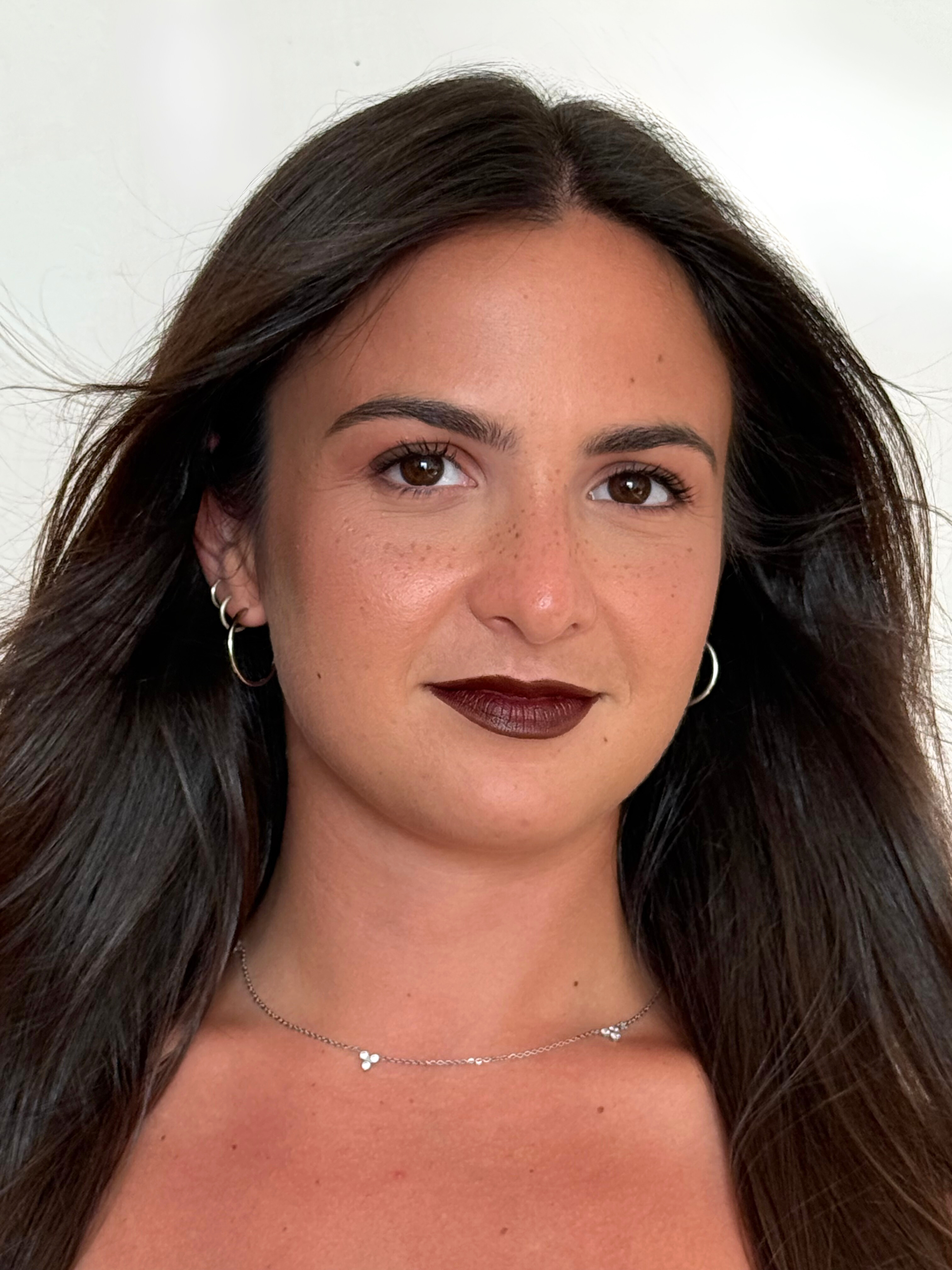 Bold burgundy lips on a fresh, glowing base.